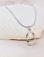 Montreal-inspired sterling pendant with curved edges