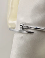 Shiny silver twist nail bracelet close-up, premium minimalist Canadian accessory.