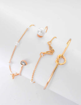 Stack of gold bracelets for women with pearls and butterfly charm