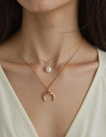 Gold layered pendant necklace with pearl and crescent charms