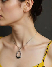 Sculpted silver pebble pendant on snake chain
