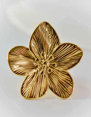 Gold blooming petal ring with detailed floral engraving on white