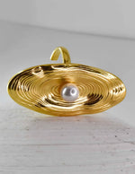 Side angle of oval pearl gold ring reflecting textured detailing
