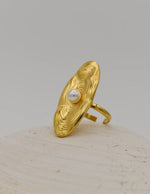 Adjustable 14k gold ring styled against white background