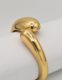 gold high-polish bangle bracelet with sculptural dual hoop detail