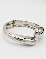 silver chunky bangles styled on flatlay white backdrop