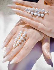 Pearl bracelet on a hand with a soft focus background