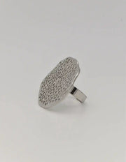 Nature-inspired silver ring on white prop display