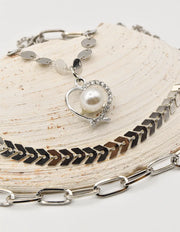 close up of christmas necklace with pearl heart pendant on silver layered chains – trending clean girl jewelry 2025 in canada