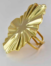 Side view of golden adjustable ring with textured starburst design