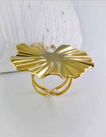 Gold leaf-shaped hair clip on a white background