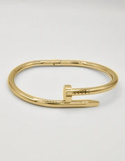 Luxury gold twist nail bangle bracelet, modern Canadian fashion accessory.