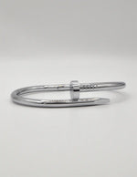 Polished silver steel twist nail bracelet, trending unisex Canadian jewellery design.